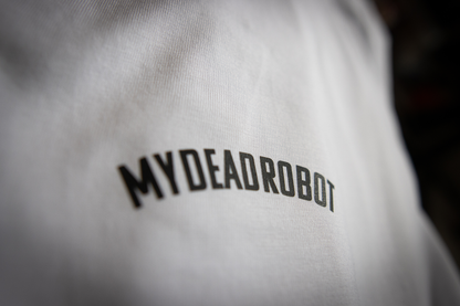 Close-up of a white garment with 'MYDEADROBOT' text on a dark background
