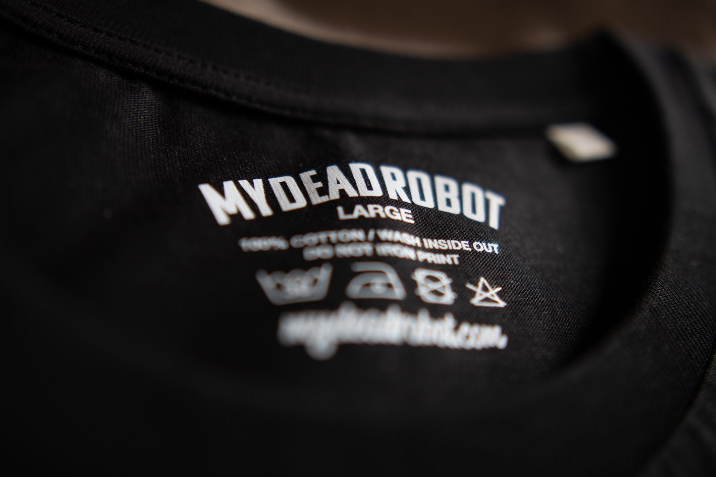 Black t-shirt with 'MYDEADROBOT' branding and laundry text on a dark background