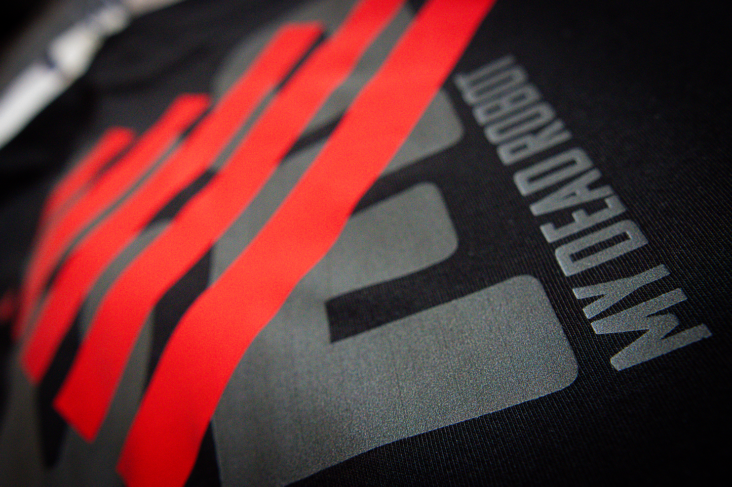 Black t-shirt with red blocky heart and grey "LOVE" text on a dark background